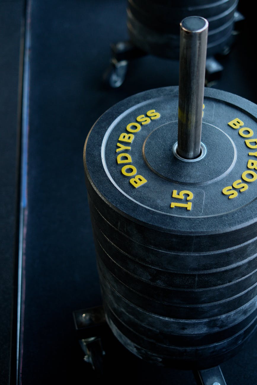 Professional sports equipment and weights in a dark atmospheric studio